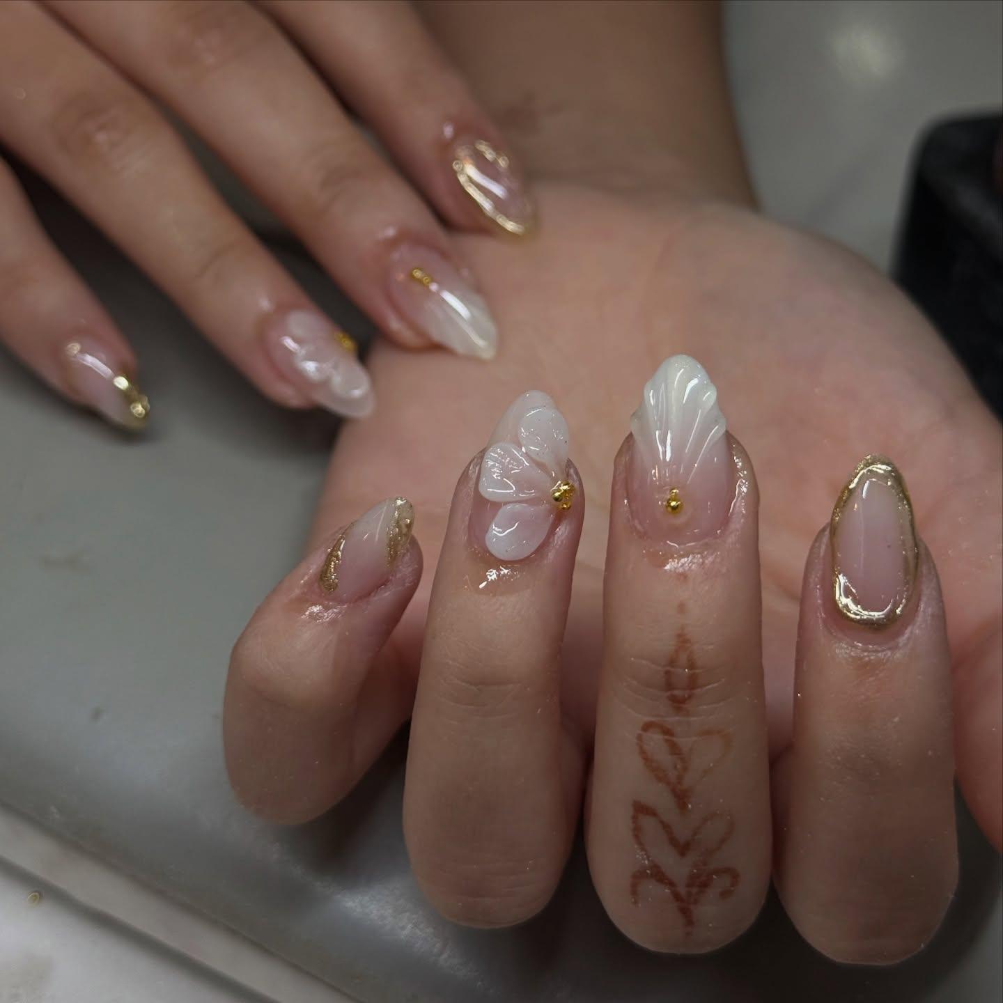 BIAB gel nails with gold foil and white 3D floral design at Nel's Nails Portsmouth